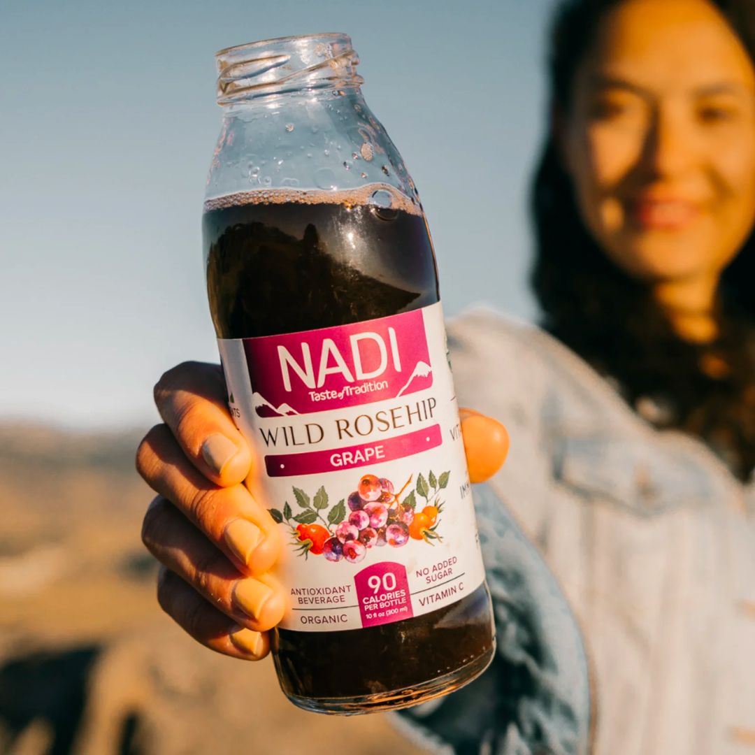 NADI Rosehip with Grape keto drink bottle held by a woman close up 